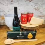 Paquete Incluye: 1 Paquete de Bucatini Delverde 500 grs., 1 Botella de Vino Merlot Cantina Casere, 2 Latas de Pelati Rosso Gargano de 400 grs., 200 grs de Parmigiano Reggiano, 1 Colador y 1 cuchara de madera.